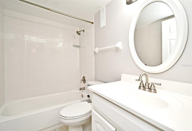 full bathroom featuring tiled shower / bath combo, vanity, and toilet