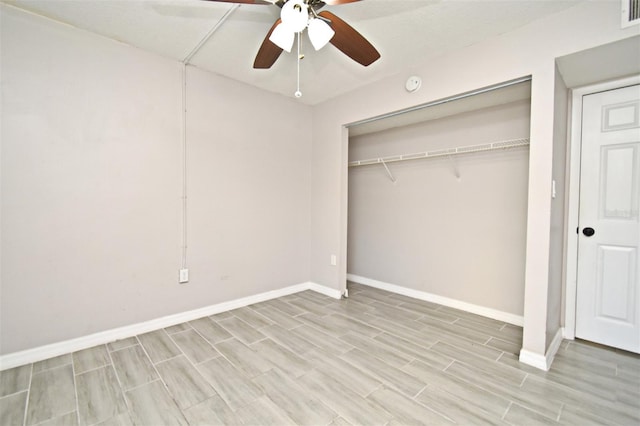 unfurnished bedroom featuring ceiling fan and a closet