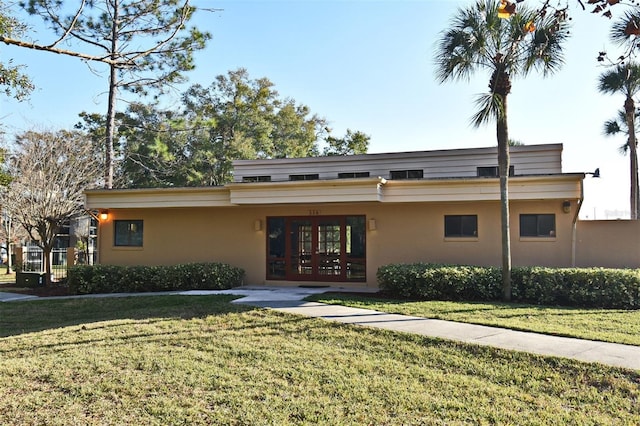 view of front facade with french doors and a front yard