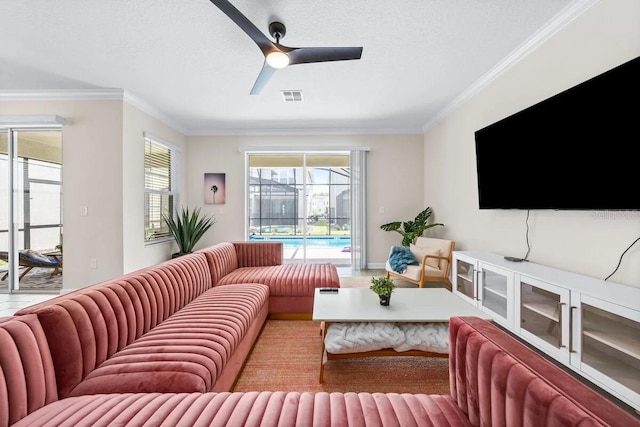 living room with a textured ceiling, ceiling fan, and crown molding