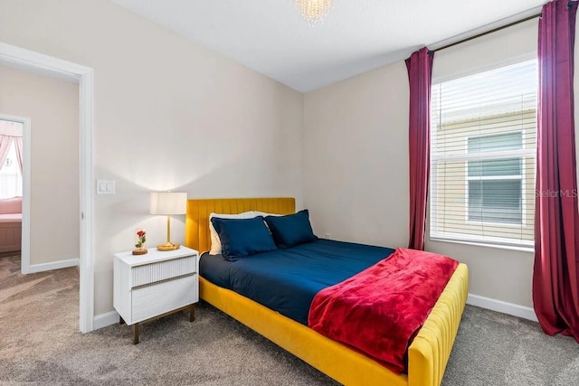 bedroom featuring carpet flooring and multiple windows