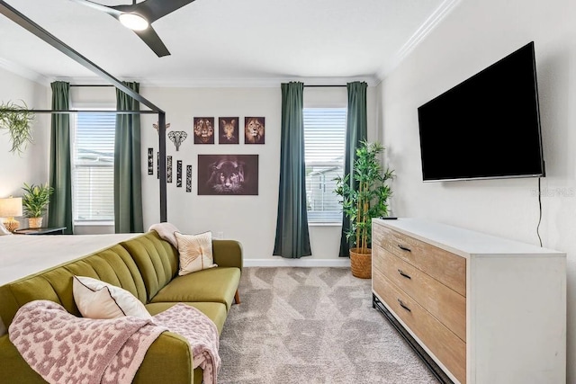 carpeted living room with ceiling fan, ornamental molding, and a wealth of natural light