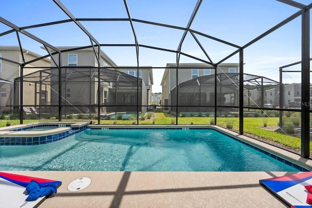 view of pool with a lanai and an in ground hot tub