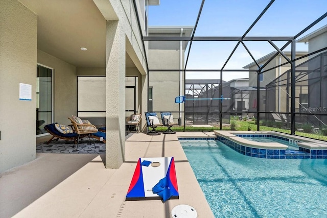 view of pool featuring a lanai, an in ground hot tub, and a patio area