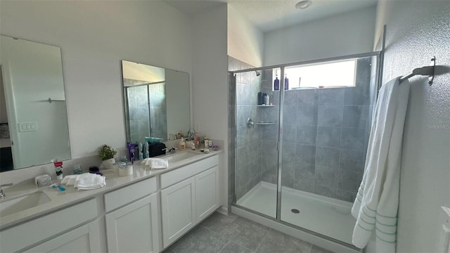 bathroom featuring tile patterned floors, vanity, and walk in shower