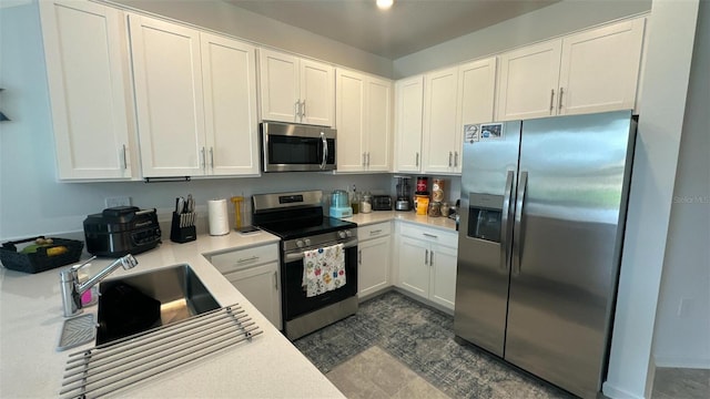 kitchen featuring sink, white cabinets, and stainless steel appliances