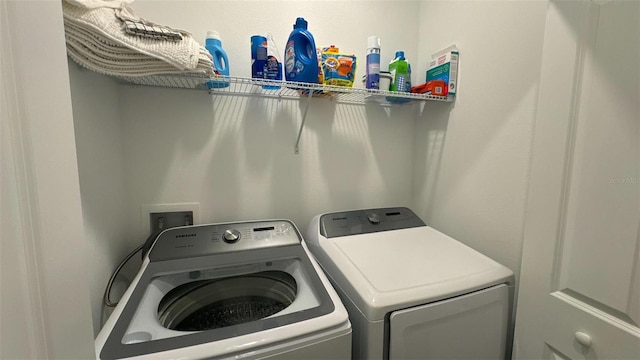 clothes washing area with washer and dryer