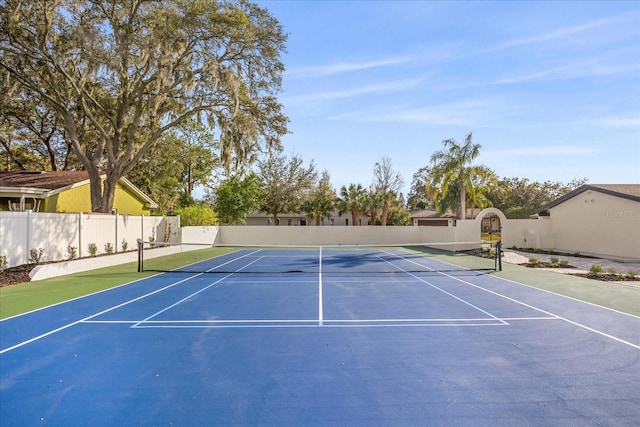 view of tennis court with fence