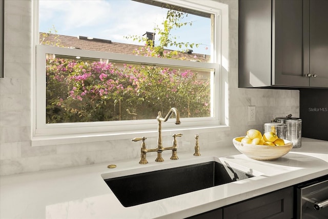 details with tasteful backsplash, light countertops, and a sink