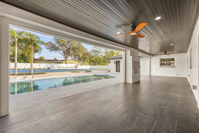 exterior space featuring a ceiling fan, fence private yard, and a fenced in pool