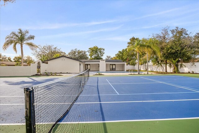 view of tennis court with fence