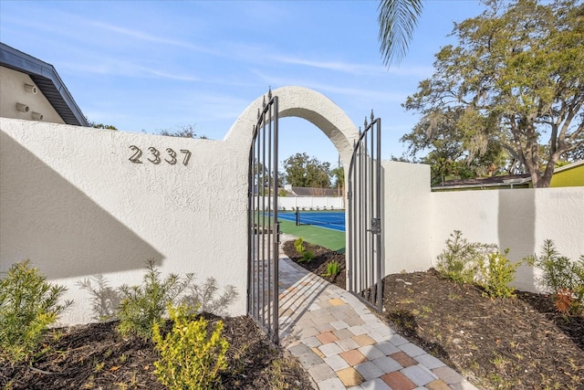 view of gate featuring fence