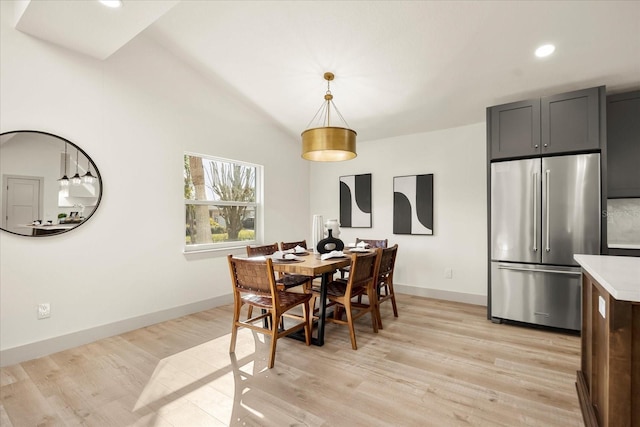 dining area featuring light wood-type flooring, baseboards, recessed lighting, and vaulted ceiling
