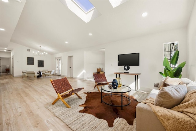 living area with vaulted ceiling, a chandelier, light wood-type flooring, a skylight, and recessed lighting