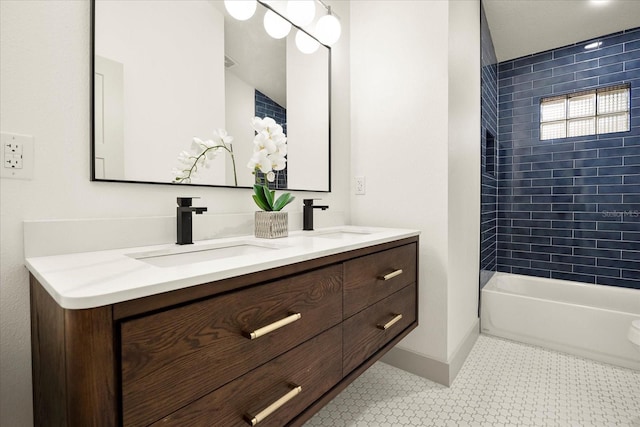 bathroom with double vanity, baseboards, and  shower combination