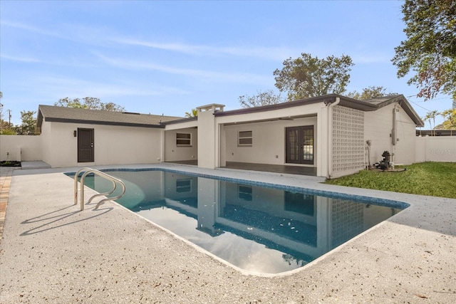 rear view of property with french doors, a patio, fence, and stucco siding