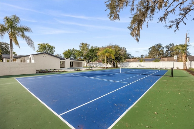 view of tennis court with fence