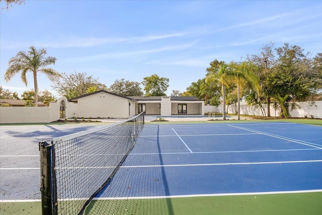 view of tennis court featuring fence