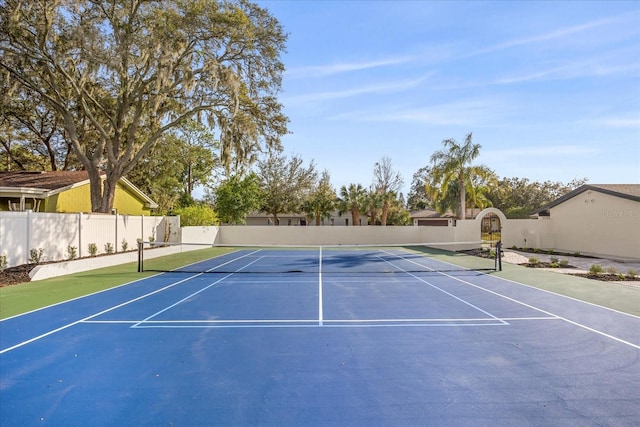 view of tennis court with fence and community basketball court