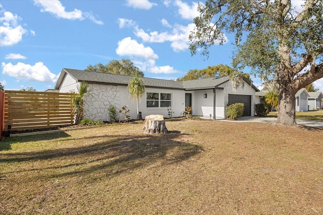 rear view of house with a yard and a garage