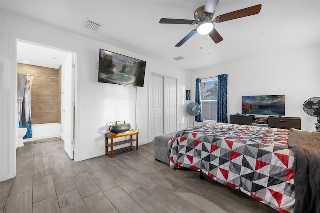 bedroom featuring ceiling fan, ensuite bath, and a closet