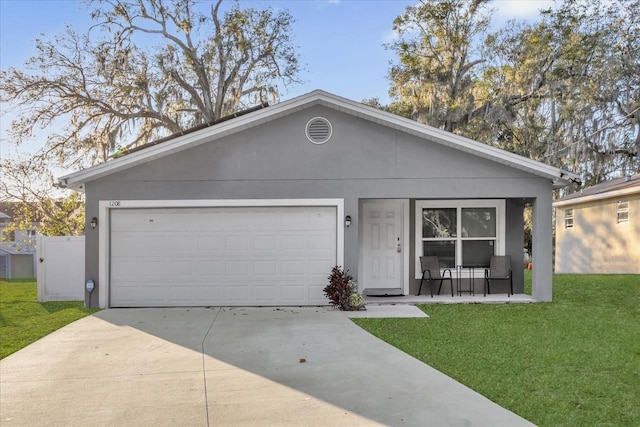 ranch-style house featuring stucco siding, driveway, a garage, and a front lawn