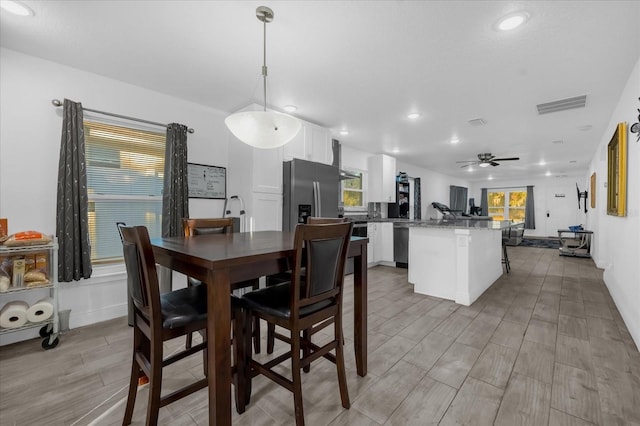 dining area featuring recessed lighting, visible vents, wood tiled floor, and a ceiling fan