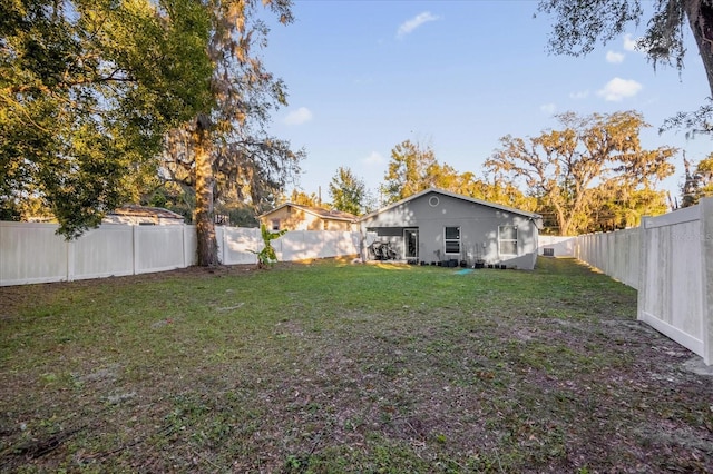 view of yard with a fenced backyard