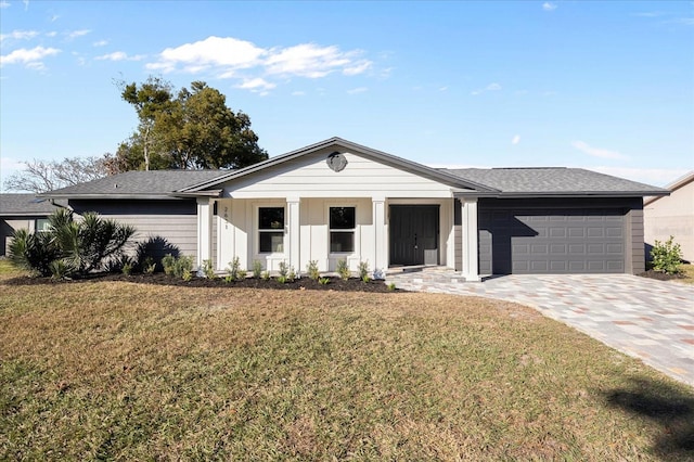 view of front of house with a front yard and a garage