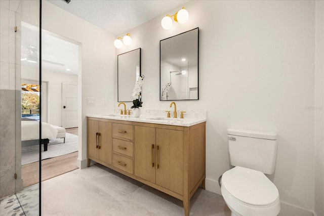 bathroom with vanity, a textured ceiling, and toilet