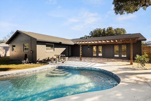 view of swimming pool featuring french doors and a patio