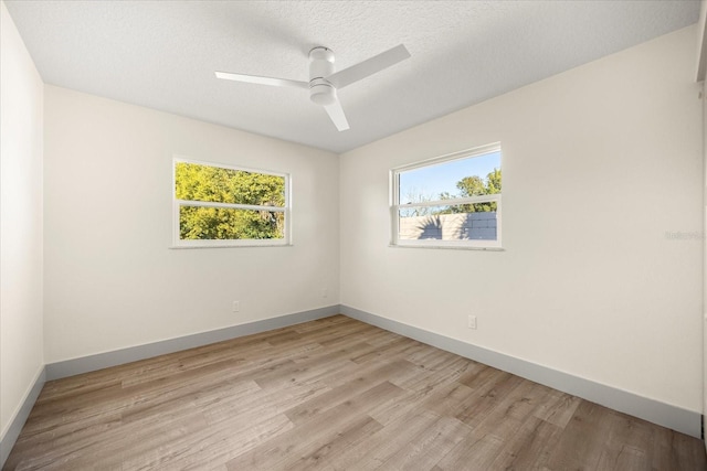 spare room featuring ceiling fan, a textured ceiling, and light wood-type flooring