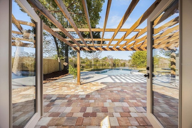 view of patio / terrace featuring a fenced in pool, a pergola, and pool water feature