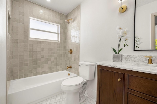 full bathroom with tiled shower / bath, vanity, and toilet