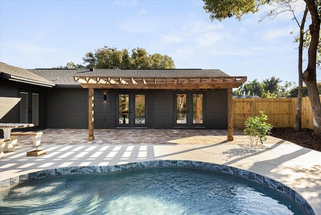 rear view of property with french doors, a patio area, fence, a fenced in pool, and a pergola