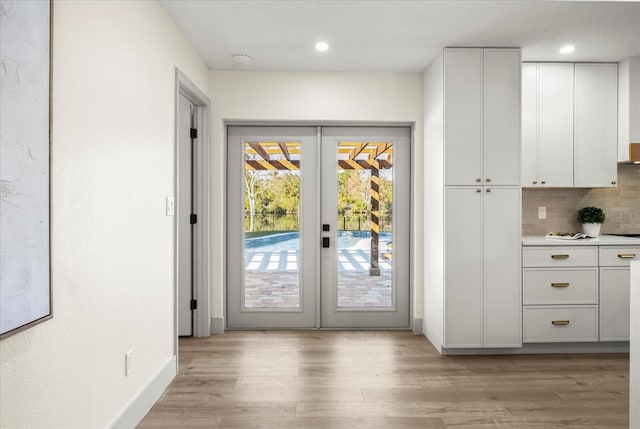 doorway to outside featuring french doors, recessed lighting, light wood-style flooring, and baseboards