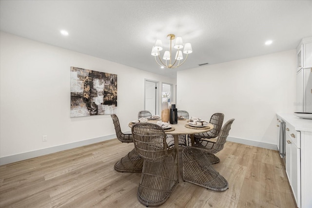 dining room featuring visible vents, baseboards, a notable chandelier, recessed lighting, and light wood-style flooring