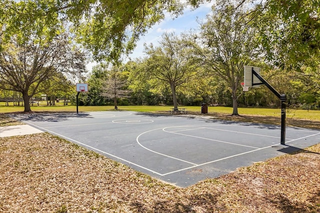 view of basketball court with a lawn and community basketball court
