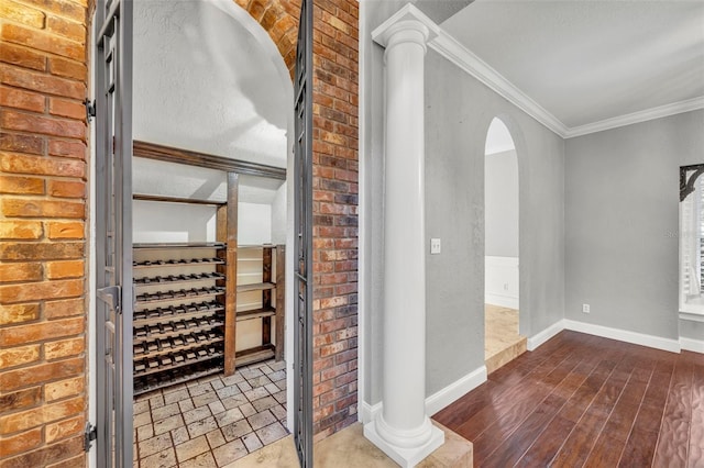 wine area with dark hardwood / wood-style flooring and ornamental molding