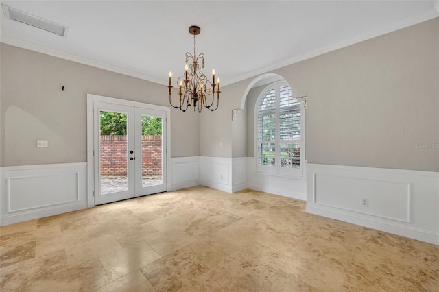 unfurnished dining area with crown molding, a chandelier, french doors, and a healthy amount of sunlight