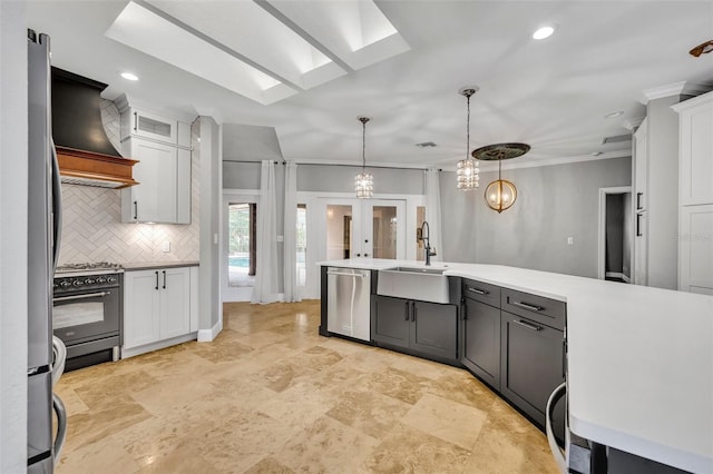 kitchen featuring white cabinetry, black gas range oven, stainless steel dishwasher, backsplash, and decorative light fixtures