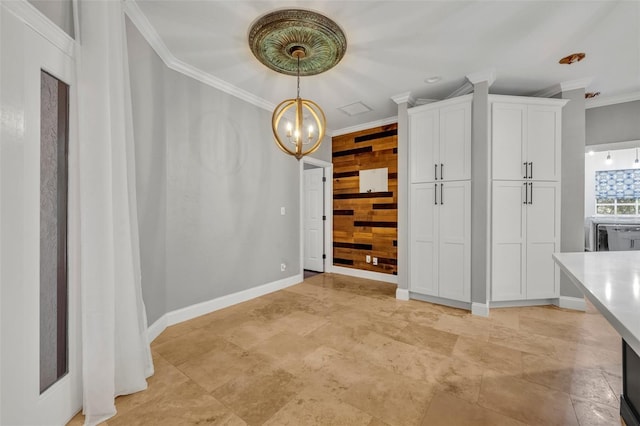 unfurnished dining area featuring wood walls, crown molding, and an inviting chandelier