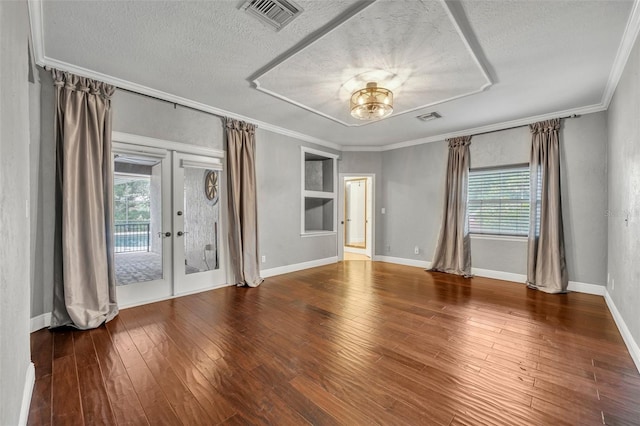 unfurnished room featuring crown molding, a textured ceiling, and french doors