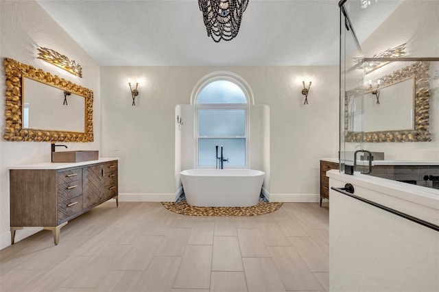 bathroom featuring a washtub and vanity