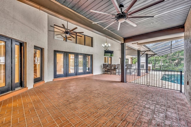 view of patio featuring ceiling fan, glass enclosure, and french doors