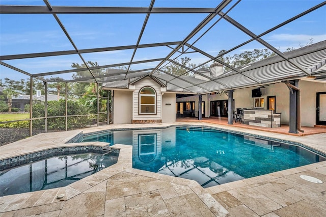 view of pool with an in ground hot tub, a bar, a patio, and a lanai