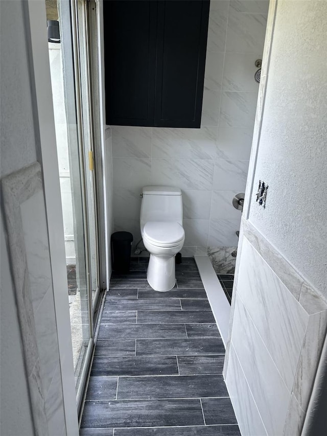 bathroom with toilet and walk in shower