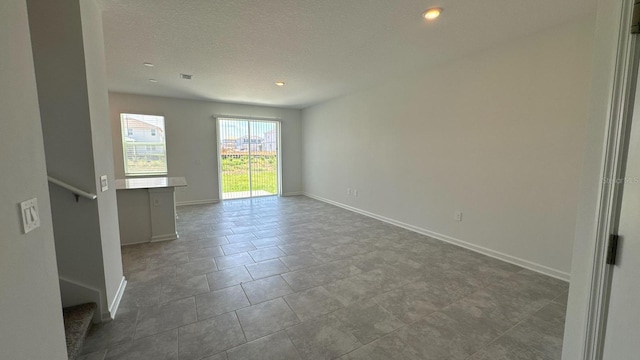 spare room with a textured ceiling