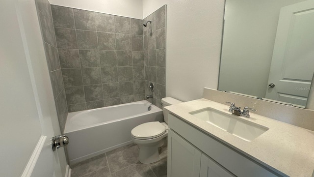 full bathroom with tile patterned flooring, vanity, toilet, and tiled shower / bath