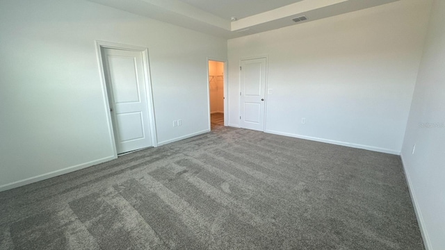 empty room featuring dark carpet